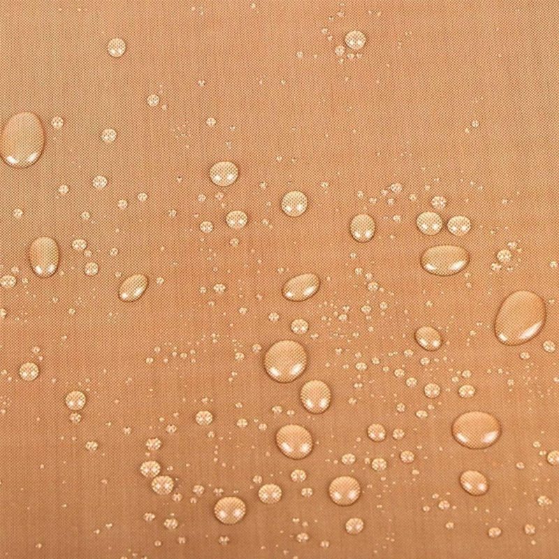 Water droplets on a smooth, light brown surface.